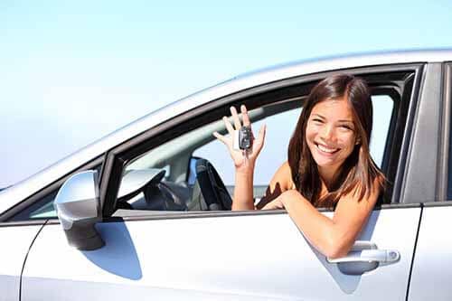 girl with car keys in white car - trade your car for SUV